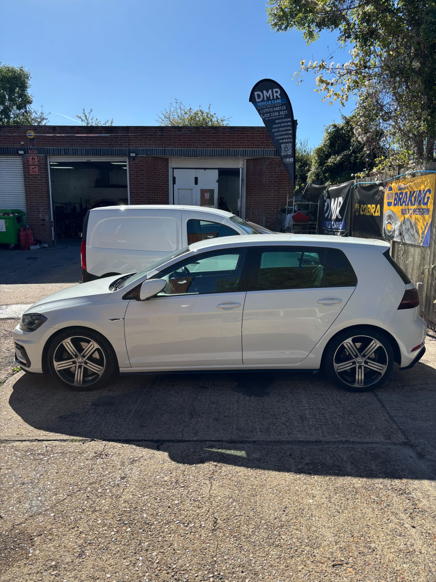 White car after bodywork repair outside the DMR workshop