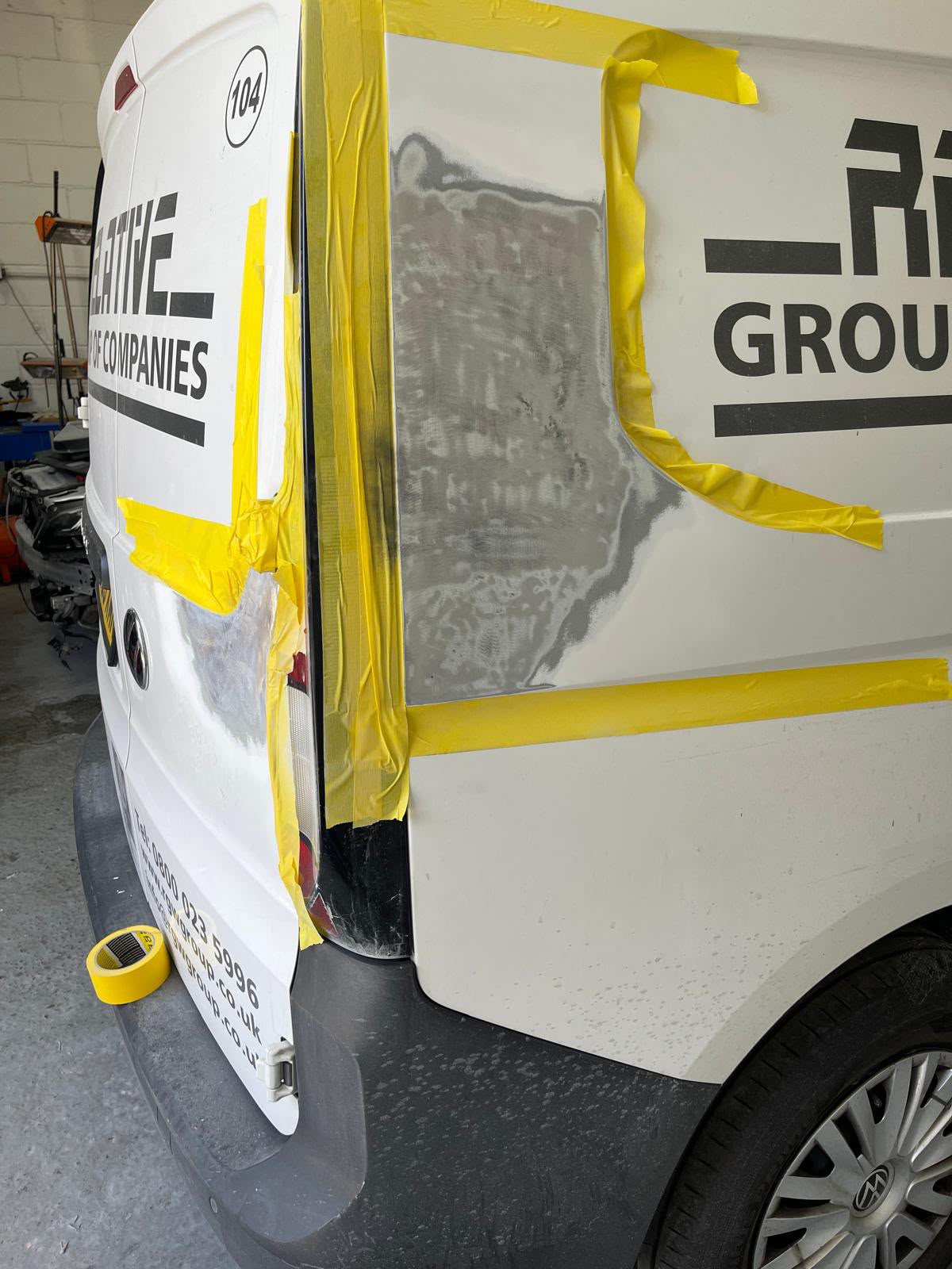 White van panel prepared for repair and refinishing